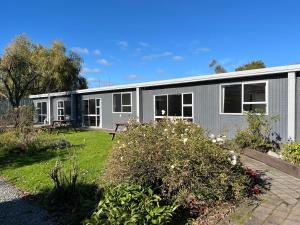 a modular house with a garden in front of it at Mt Dobson Motel in Kimbell