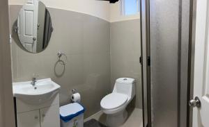 a bathroom with a toilet and a sink and a mirror at Hostal sol del norte in Paipote +40 photos