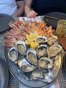 a plate of oysters and shrimp on a table at Casa sulla Laguna CASTELLO in Venice