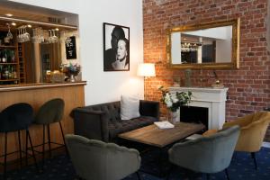 a living room with a couch and a table and chairs at Hotel Continental Relax & Spa, BW Signature Collection in Halmstad