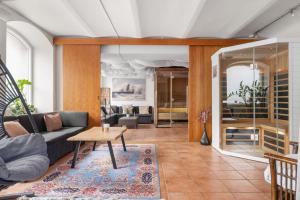 a living room with a couch and a table at Hotel Continental Relax & Spa, BW Signature Collection in Halmstad