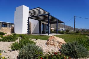 a modern house with a black and white facade at Villas By George in Afiartis