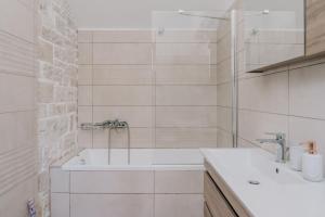 a white bathroom with a tub and a sink at Guince House by All About Paxos in Oziás +25 photos