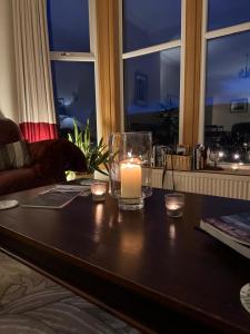 a candle sitting on a table in a living room at Beinn Bhracaigh in Pitlochry +66 photos