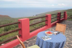 a table with a bowl of fruit on top of a balcony at Casa Rural la Hojalata in Mocanal