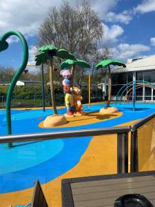 a water park with a playground with palm trees at Haven Caravan Park Cala Gran 3 bedrooms Fleetwood in Fleetwood