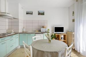 a kitchen with a table with a vase on it at Gîte La Salamandre in Mosnes