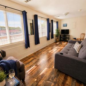 a living room with a couch and two windows at Buccaneer Bay Bungalow #6 in Sunrise Beach