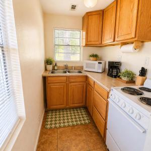a kitchen with wooden cabinets and a white stove top oven at Buccaneer Bay Bungalow #6 in Sunrise Beach