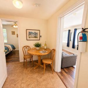 a dining room with a table and chairs and a bedroom at Buccaneer Bay Bungalow #6 in Sunrise Beach
