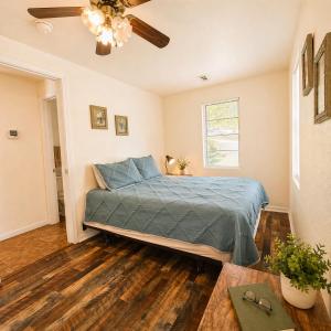 a bedroom with a bed and a ceiling fan at Buccaneer Bay Bungalow #6 in Sunrise Beach