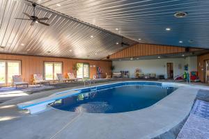 a swimming pool in a house with a ceiling at Rough Cut Lodge in Gaines