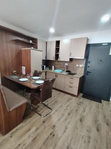 a kitchen with a table and chairs in a room at Silver Moon 1 in Veliko Gradište