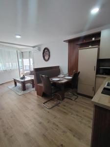 a kitchen with a table and chairs in a room at Silver Moon 1 in Veliko Gradište