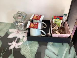 a tray with a jar of tea and other snacks at La Bricole in Dinant +43 photos