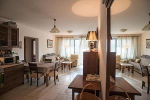 a kitchen and living room with a table and chairs at Cozy home in Petrovac na Moru