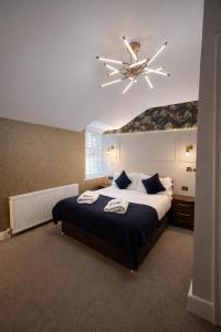 a bedroom with a large bed with a ceiling fan at The Sun Hotel in Warkworth
