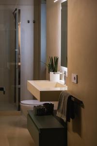 a bathroom with a sink and a toilet and a mirror at VILLA GIULIA 8, Emma Villas in Nemi