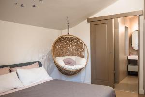 a bedroom with a bed and a hanging basket at VILLA GIULIA 8, Emma Villas in Nemi +35 photos