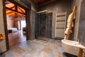 a bathroom with a glass shower and a sink at Casa Vecchia Bed&Breakfast in Bossolasco