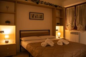 a bedroom with a bed with two towels on it at Al Civico 23 in Castiglione del Lago