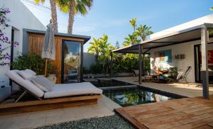 a backyard with a hammock and a swimming pool at Villa Ha Taew in Sant Josep de sa Talaia