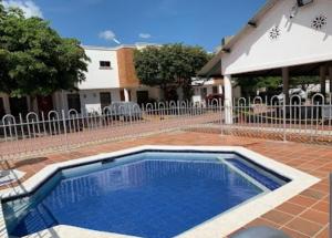 a swimming pool in a yard with a fence at Casa Norte Exclusive Home-Amplia, amoblada Valledupar in Valledupar