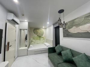 a living room with a green couch and a bathroom at Sunrise Apartments in Xóm Niêm +49 photos