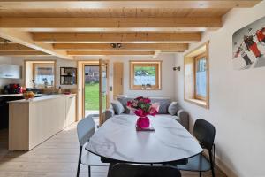 a dining room and kitchen with a table and chairs at Chalet Individuel - Saflalou in Combloux