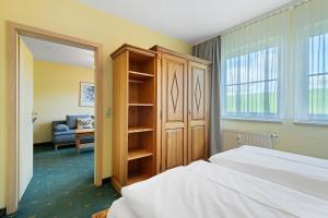 a bedroom with a bed and a book shelf at Apartment mit Gartenblick K1 106 in Spalt