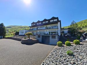a large building with a driveway in front of it at Pension Mosella , Appartement-Wohnung mit Balkon und Moselblick in Sankt Aldegund