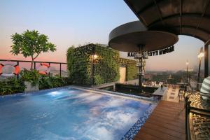 a swimming pool on the roof of a building at Solar Premium Hotel & Spa in Hanoi