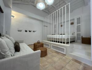 a living room with a couch and a bed at Stavlo Open Plan Cottage Zakynthos in Koríthion