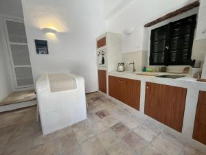 a kitchen with a sink and a counter top at Stavlo Open Plan Cottage Zakynthos in Koríthion