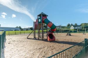 a playground with a slide in the sand at Wild Atlantic Camp in Creeslough