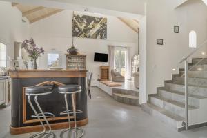 a living room with a bar with a stool at Villa Pilali in Kefallonia