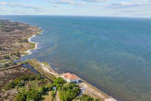 an aerial view of the ocean and a house at 7659 - Sound Garden in Avon