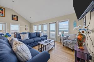 a living room with a blue couch and chairs at 7659 - Sound Garden in Avon