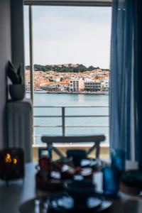 a table with a view of the water from a window at Aether View Premium Views in Central Mytilene in Mytilene