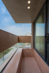 a room with a large window with a view at The Charm Hotel Phan Thiet in Ấp Bình Hưng