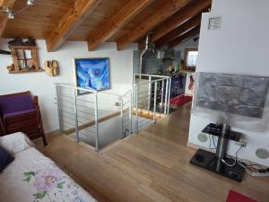 a living room with a staircase in a house at la casa del marmottaio in Crépin