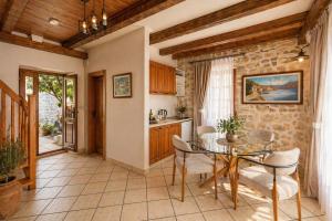a kitchen and dining room with a table and chairs at Conte Hotel & Restaurant in Perast