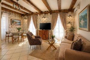 a living room with a couch and a table at Conte Hotel & Restaurant in Perast