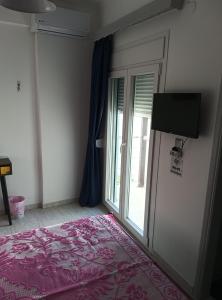 a bedroom with a bed and a sliding glass door at Sophia in Kokkari +15 photos