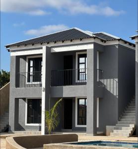 a rendering of a house with a solar roof at Overflow Accommodation Lodge in Louis Trichardt