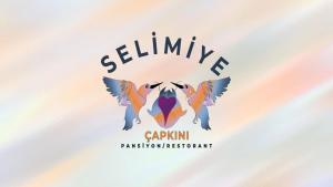 a logo of a goat with butterfly wings at Selimiye Çapkını in Marmaris
