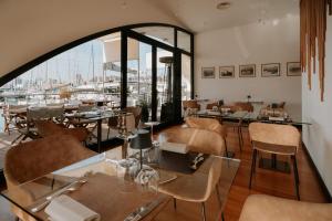 a restaurant with tables and chairs and a large window at Locanda da Toto in Genoa