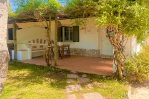a patio with a table and chairs in front of a house at Quinta da Vala - Veranda Suite 1 in Porches