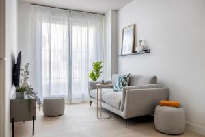 a living room with a couch and a chair at Calido Alcobendas in Alcobendas +22 photos