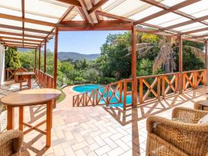 a patio with a table and chairs and a pool at The Gentleman in Montagu